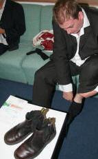Bass player Michael Bailey putting his boots on